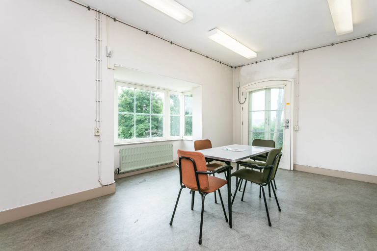 simple-meeting-room-with-window-light-and-eclectic-chairs